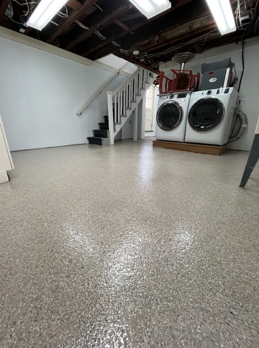 Gray flake epoxy floor in a residential basement laundry area