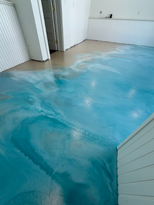 Bright blue metallic epoxy floor in a residential room