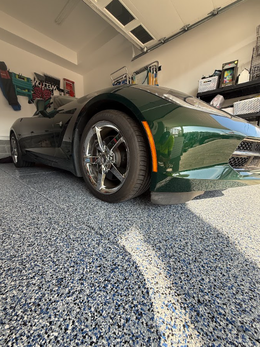Blue flake epoxy garage floor with a green Corvette parked on it