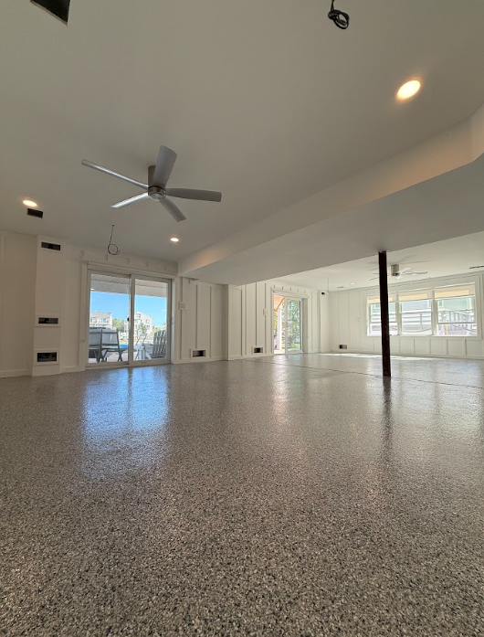 Gray flake epoxy floor across an open-concept residential floor plan