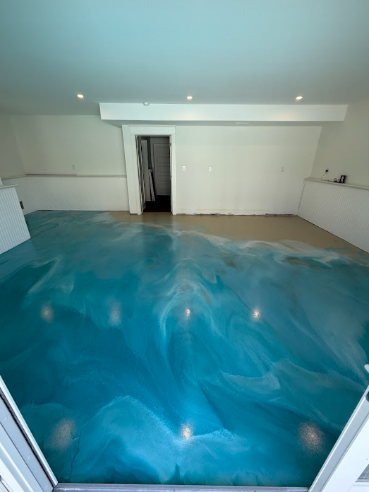 Teal and white metallic epoxy floor in a residential room