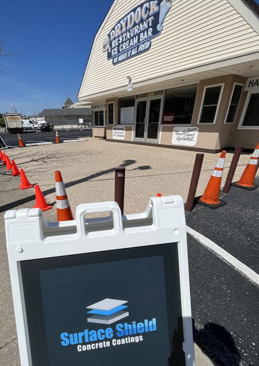 Surface Shield sign at the Drydock Restaurant with a freshly coated commercial lot in Cape May County, NJ